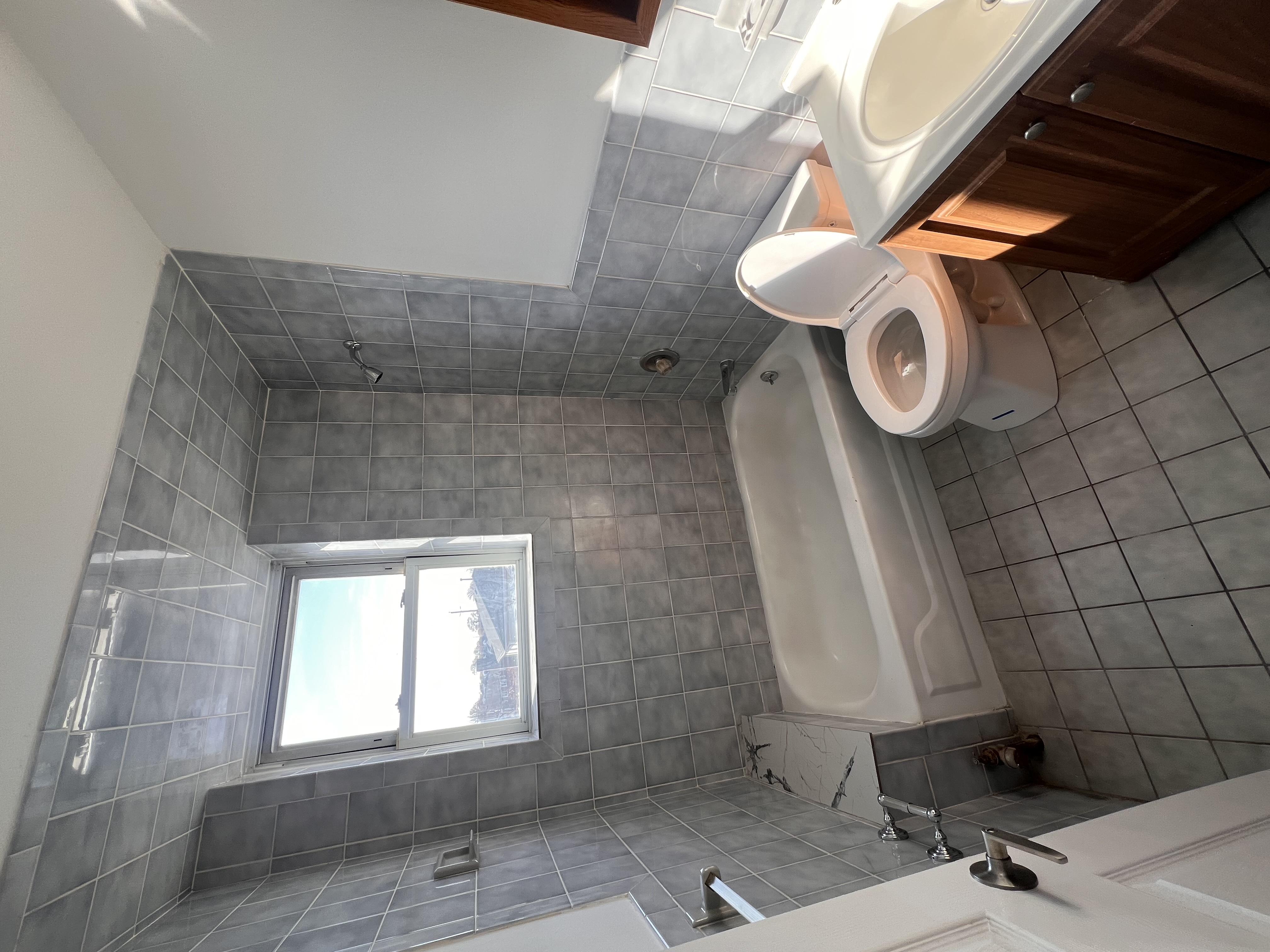 Renovated Bathroom with Brand New Tile Walls